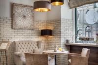 a living room with a couch and a table at Hotel Florenc in Prague