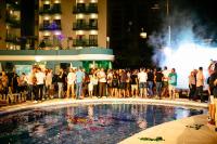 a crowd of people standing around a pool at night at Hotel Ritual Torremolinos- Adults Only in Torremolinos