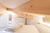 A bed or beds in a room at La Giostra Home Apartments