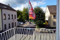 a flag on a balcony of a building at Hotel Hohenstein -Radweg-Messe-Baldeneysee in Essen