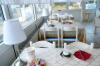 a room with a table and chairs and a table and a room with a table at Hotel Hohenstein -Radweg-Messe-Baldeneysee in Essen