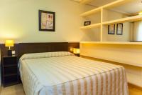 A bed or beds in a room at Apartamentos Tres Luces