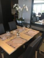 een tafel in een restaurant met wijnglazen erop bij Hôtel Relais d'Étretat in Bolbec