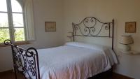 Posteľ alebo postele v izbe v ubytovaní villa montalcino palazzina castelverdelli