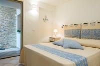 A bed or beds in a room at Apartment in S'Abba e Sa Pedra with pool