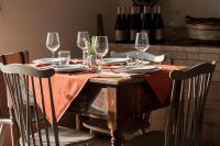 a table with wine glasses and plates on it at Resort Fontes Episcopi in Aragona