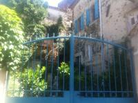 a blue gate in front of a building at La belle endormie in Cabrerolles