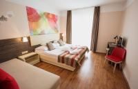 Posteľ alebo postele v izbe v ubytovaní Harmónia Hotel Sárvár