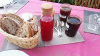 a picnic table with a basket of bread and jam at Résidence de Vaux in Nans-sous-Sainte-Anne