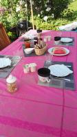 a pink table with food on top of it at Résidence de Vaux in Nans-sous-Sainte-Anne