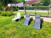 three lounge chairs sitting on the grass in a yard at Gîte de la Grande Fontaine in Isches