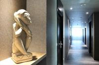 a statue of a woman sitting on a shelf in a hallway at Ashare Hotel in Jiaoxi