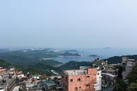 a view of a city with the ocean in the background at Yuan-Yee Homestay in Jiufen