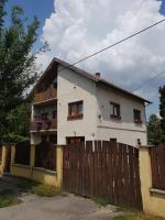 a white house with a wooden fence in front of it at Etyek Rustic Home in Etyek