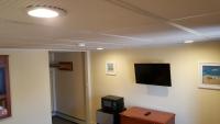 a room with a flat screen tv on a wall at Atlantic Motel in Point Pleasant Beach