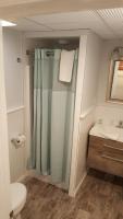 a bathroom with a shower and a toilet and a sink at Atlantic Motel in Point Pleasant Beach
