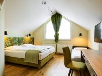 A bed or beds in a room at Das Grüne Hotel zur Post - 100 % BIO
