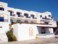 a white building with balconies on the side of it at Patmos Paradise Hotel in Kámbos