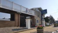 a building with a balcony on top of it at Atlantic Motel in Point Pleasant Beach