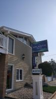 a building with a sign in front of it at Atlantic Motel in Point Pleasant Beach