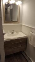 a bathroom with a sink and a mirror at Atlantic Motel in Point Pleasant Beach