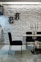 a dining room with a table and chairs and a brick wall at HL53 B&amp;B in Hualien City