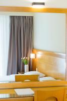 a hotel room with two beds and a window at Athinais Hotel in Athens