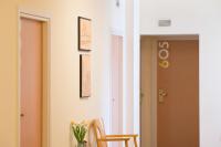 a hallway with two chairs and a vase of flowers at Athinais Hotel in Athens