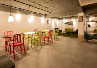 a dining room with colorful chairs and a table at Light Hostel in Chiayi City