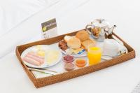 a tray of breakfast foods and drinks on a table at Athinais Hotel in Athens