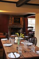 a wooden table with yellow flowers on top of it at The Red Lion Inn in Babcary