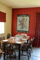 a dining room with a wooden table with chairs at The Red Lion Inn in Babcary