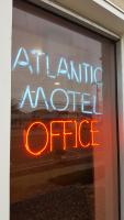 a neon sign in the window of a store at Atlantic Motel in Point Pleasant Beach