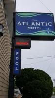 a sign for the atlantic motel next to a building at Atlantic Motel in Point Pleasant Beach