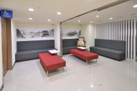 a waiting room with two benches and red seats at CU Hotel Taipei in Taipei