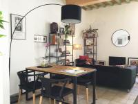 a dining room with a table and a couch at Appartement Arles Centre Historique in Arles