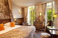 a hotel room with a bed and a chair at Au Manoir Saint Germain in Paris
