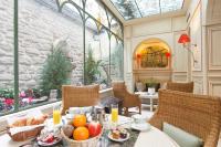 a dining room with a table with fruit on it at Au Manoir Saint Germain in Paris