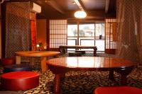a room with tables and chairs and a window at Terakoya Hanatei in Asago