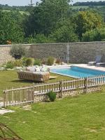 a backyard with a fence and a swimming pool at Les Hauts De Chalonne in Le Gond-Pontouvre