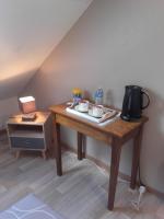 a wooden table with a tea kettle on top of it at Chambre d&#39;hôtes La Guéjaillière in Beaumont-Pied-de-Boeuf