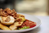 a plate of food with meat and french fries at Hotel Abastos Plaza in Mexico City