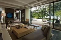 a living room with a couch and a table at Rosewood Phuket in Patong Beach