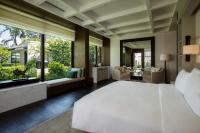 a bedroom with a large white bed and large windows at Rosewood Phuket in Patong Beach