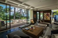 a living room with a couch and a table at Rosewood Phuket in Patong Beach