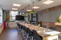a conference room with a long table and chairs at Stayokay Hostel Amsterdam Vondelpark in Amsterdam
