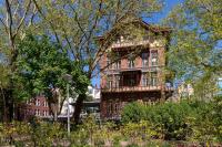 an old brick building in the middle of a garden at Stayokay Hostel Amsterdam Vondelpark in Amsterdam