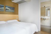 Łóżko lub łóżka w pokoju w obiekcie Hotel Olatu