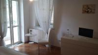 Televízia a/alebo spoločenská miestnosť v ubytovaní B&B Casa di Laura