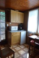 a kitchen with a white refrigerator and a microwave at Chalet Vintage in Pollieu